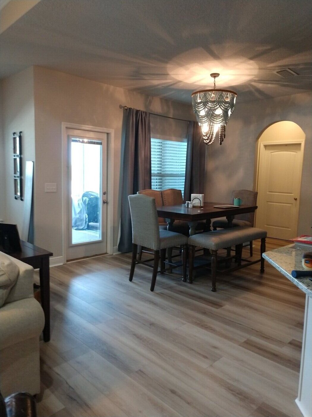 Luxury vinyl plank flooring installed through a kitchen and dining area